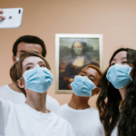 Healthcare professionals taking a selfie during COVID Pandemic wearing masks.