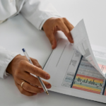 Healthcare professional reviewing medical charts and patient data during a clinical assessment