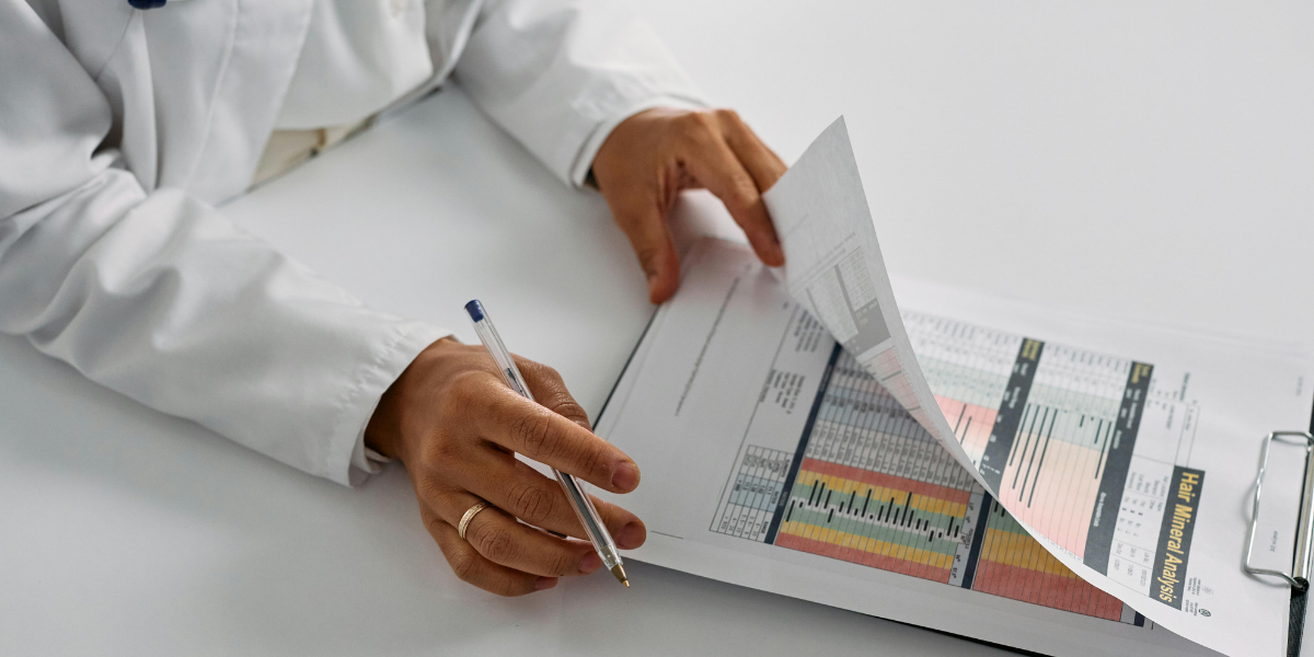Healthcare professional reviewing medical charts and patient data during a clinical assessment