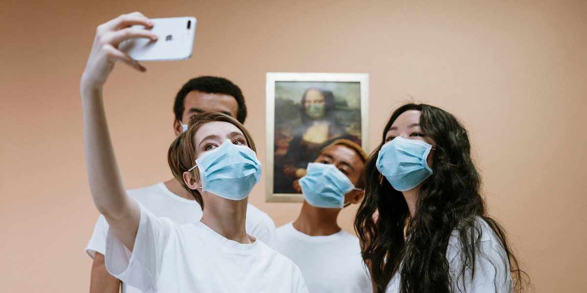 Healthcare professionals taking a selfie during COVID Pandemic wearing masks.