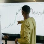 Healthcare professionals analyzing medical data charts on a digital screen in a smart hospital setting.