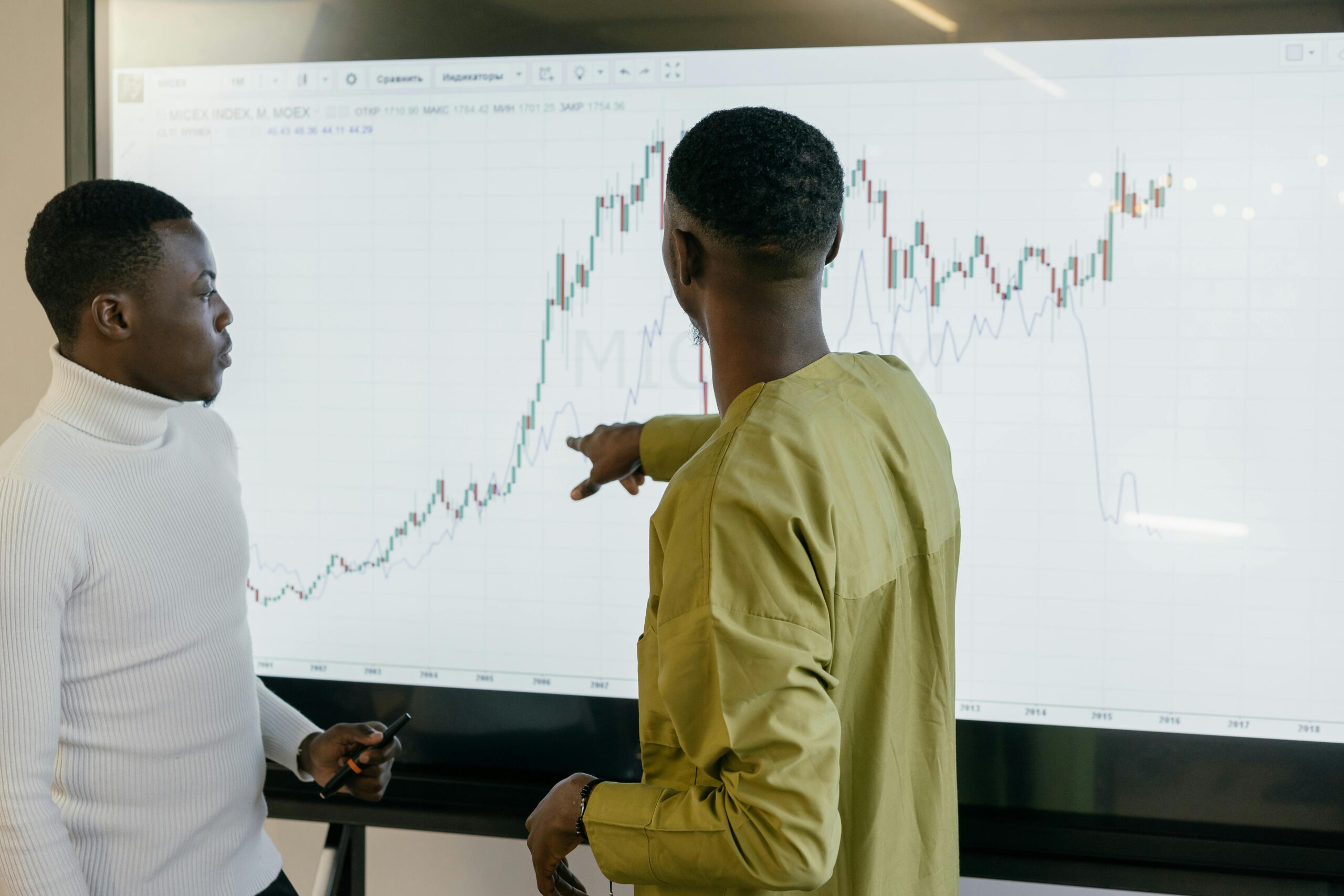 Healthcare professionals analyzing medical data charts on a digital screen in a smart hospital setting.