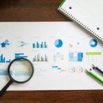 Healthcare data charts and analytics report being reviewed for medical performance and patient insights