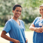 Bilingual Nurses wearing hospital scrubs smiling