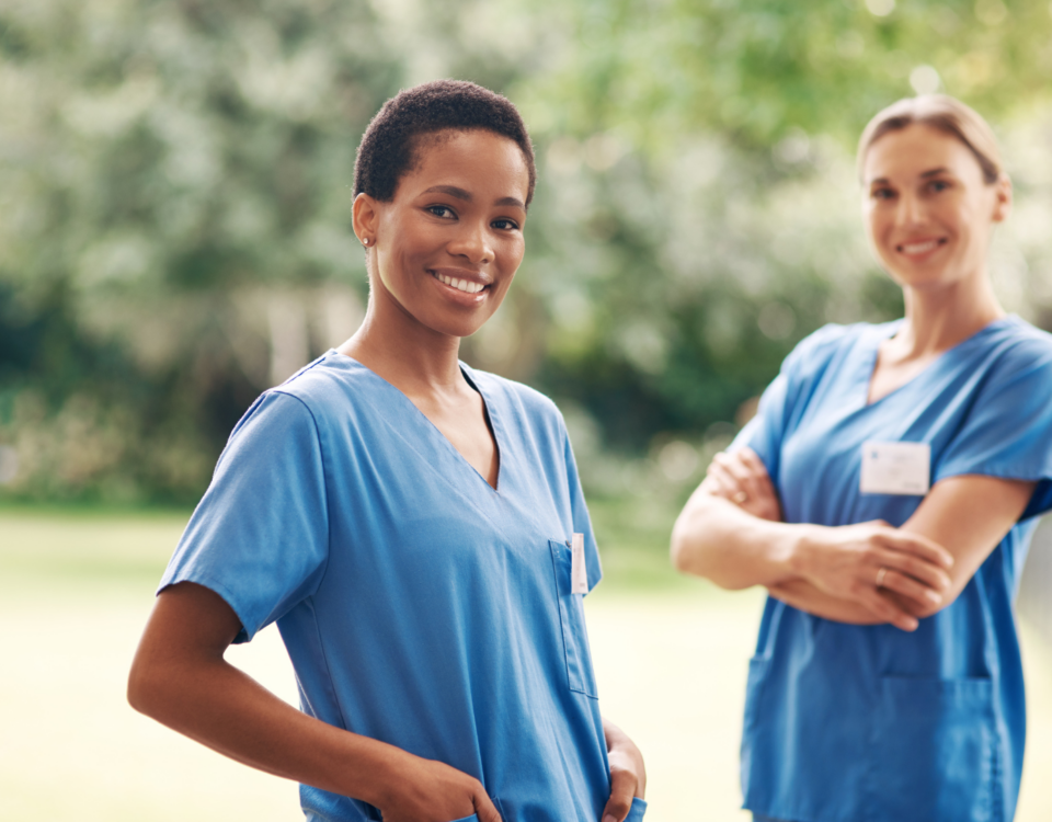 Bilingual Nurses wearing hospital scrubs smiling
