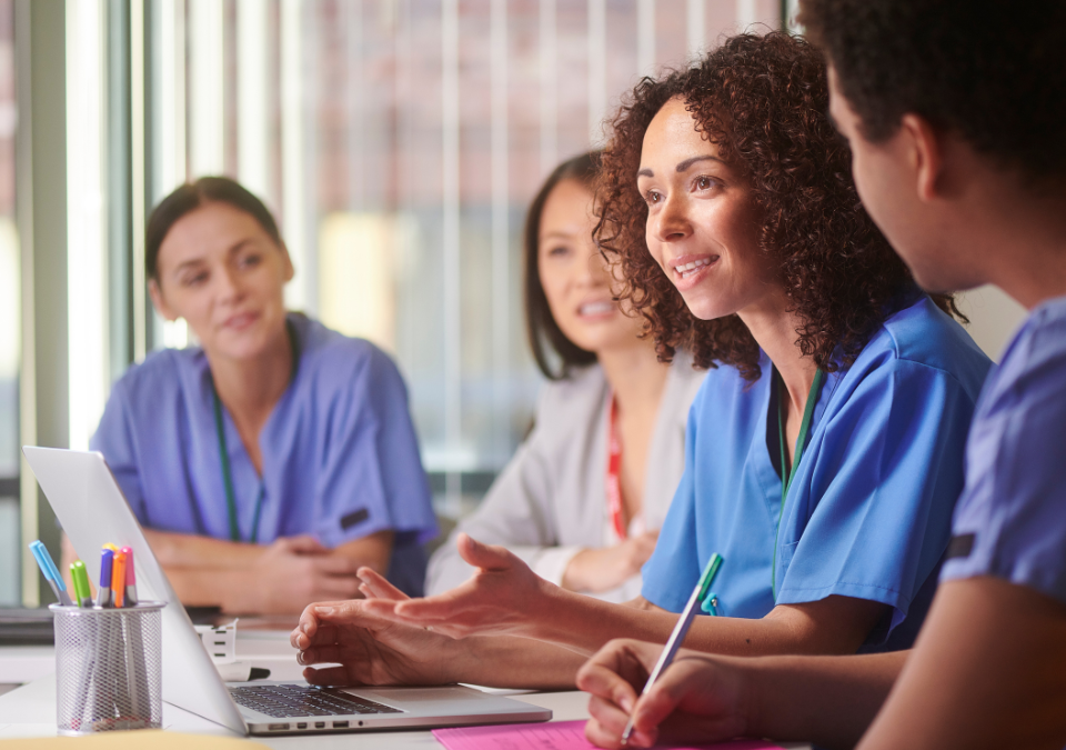 Here are alt text options for a diverse permanent healthcare staff image: Best SEO Options (includes keyphrase): 1. "Diverse permanent healthcare staff team working together to reduce agency staffing dependence