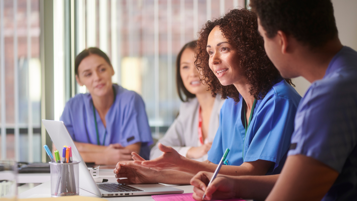 Here are alt text options for a diverse permanent healthcare staff image: Best SEO Options (includes keyphrase): 1. "Diverse permanent healthcare staff team working together to reduce agency staffing dependence