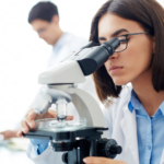 Medical lab technologist using microscope for sample analysis representing healthcare workforce shortage