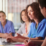 Diverse group of healthcare professionals (different ethnicities/backgrounds) looking at credentials/documents or in a professional setting