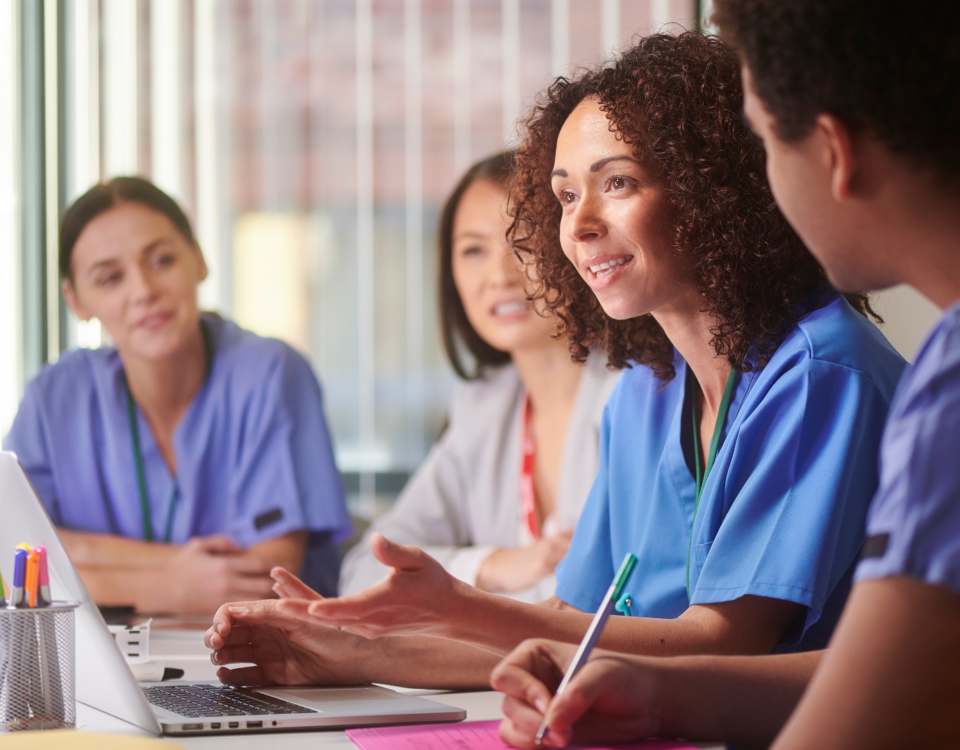 Diverse group of healthcare professionals (different ethnicities/backgrounds) looking at credentials/documents or in a professional setting