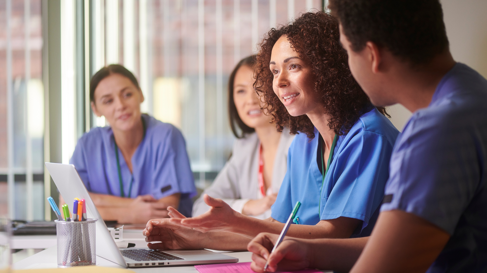 Diverse group of healthcare professionals (different ethnicities/backgrounds) looking at credentials/documents or in a professional setting