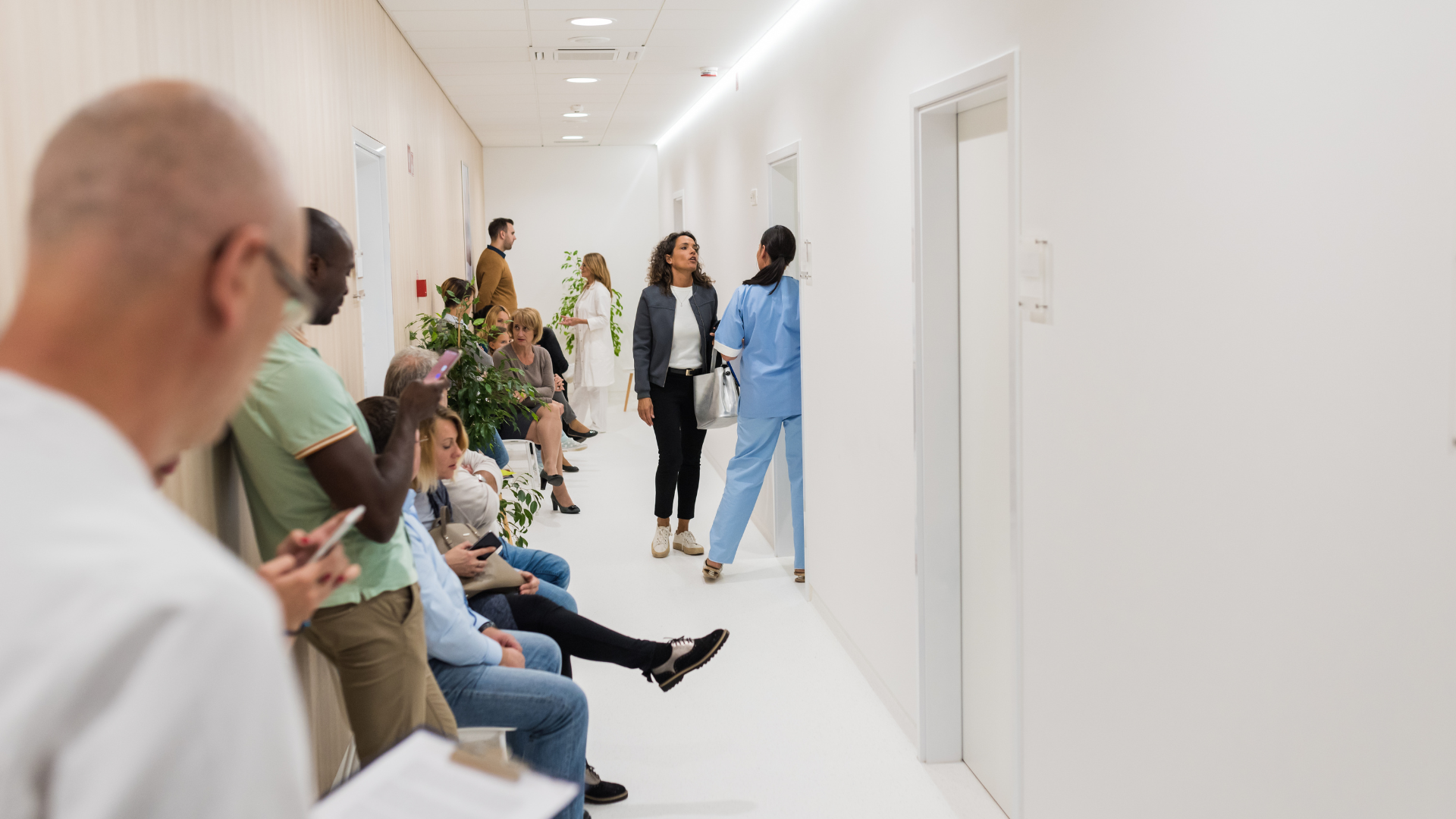 Patients waiting in hospital emergency room, representing delays caused by allied health staff shortages