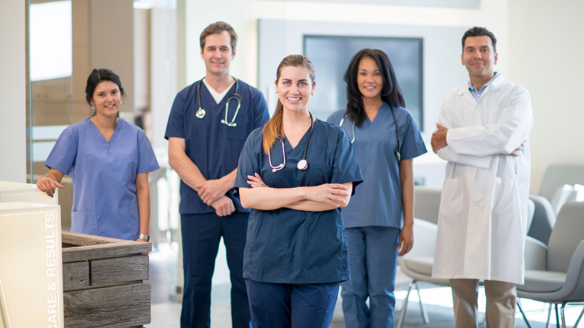 Group of allied health professionals including physiotherapist, occupational therapist, medical laboratory technologist, and speech-language pathologist working together in a healthcare setting, representing diverse allied health professions in Canada.