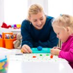 Occupational therapist assisting a child with developmental activities, illustrating school and pediatric OT roles in Canadian healthcare and education settings.