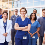 Diverse team of healthcare professionals including nurses, doctors, physiotherapists, and medical technicians collaborating in a modern clinic setting