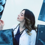 medical radiation tech looking at xrays