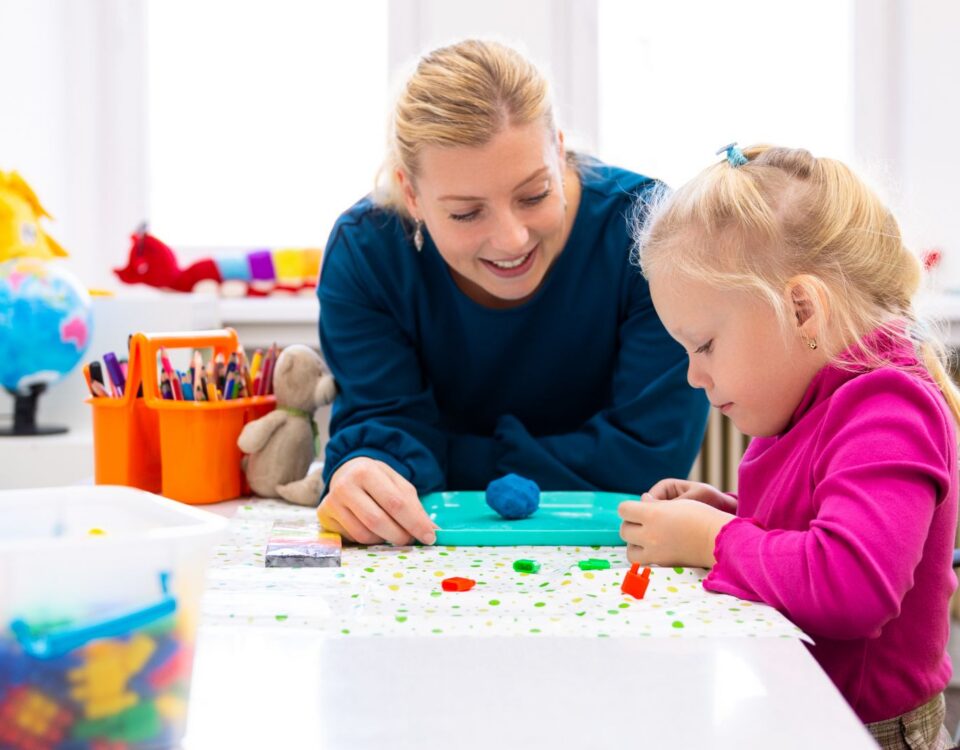 Occupational therapist assisting a child with developmental activities, illustrating school and pediatric OT roles in Canadian healthcare and education settings.