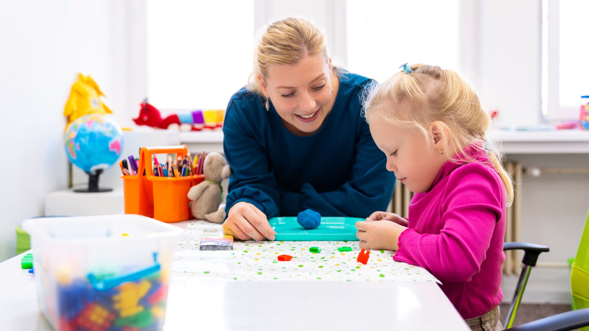 Occupational therapist assisting a child with developmental activities, illustrating school and pediatric OT roles in Canadian healthcare and education settings.