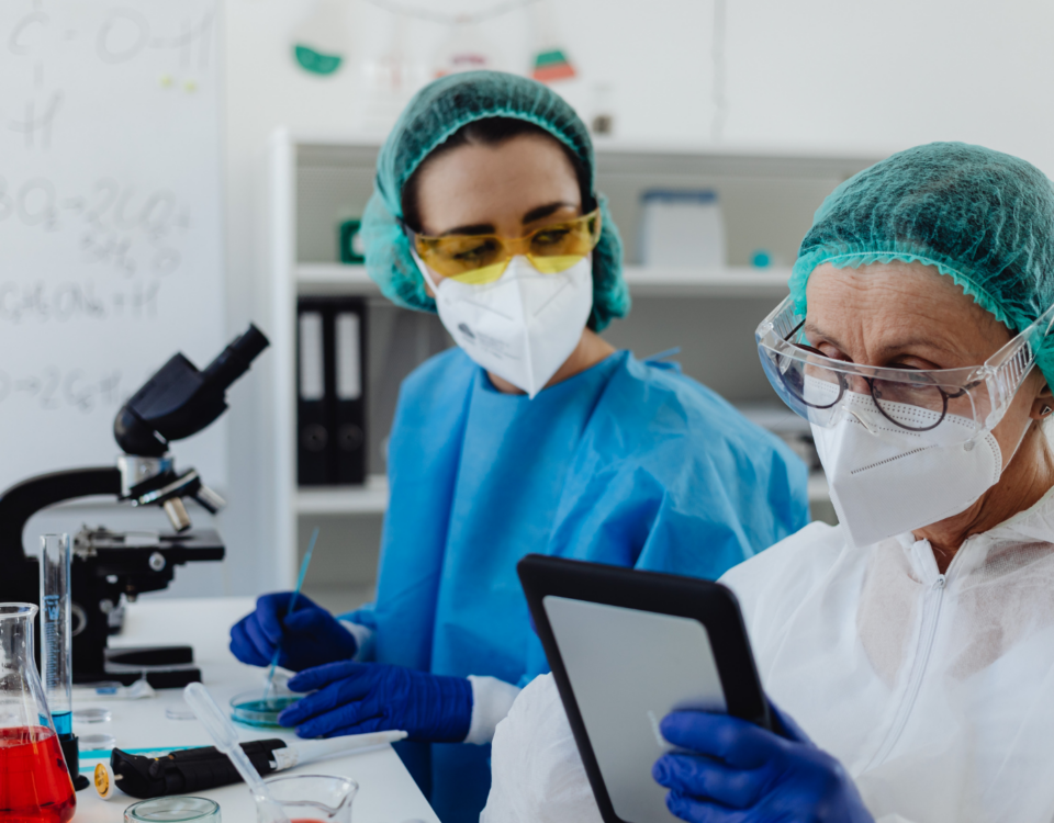 Two medical laboratory technicians working together at lab equipment, representing Canada's medical technologist shortage across healthcare facilities.