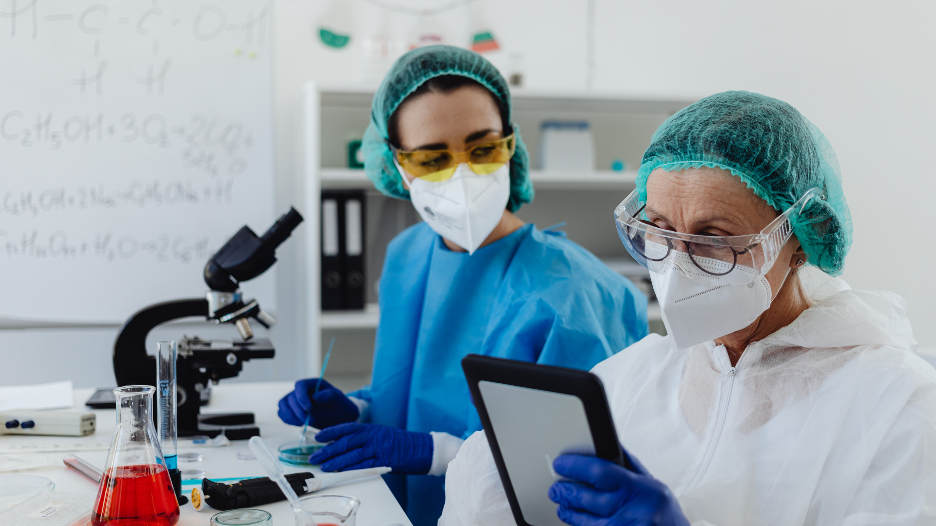 Two medical laboratory technicians working together at lab equipment, representing Canada's medical technologist shortage across healthcare facilities.