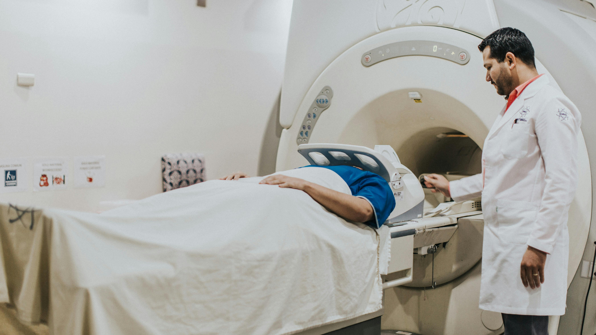 Nuclear medicine technologist (NMT) performing an MRI