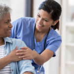 Licensed Practical Nurse at her job at hospital working with an old lady